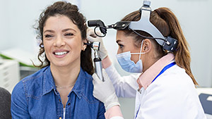 hearing exam otolaryngologist doctor checking woman s ear using otoscope auriscope medical clinic hearing exam otolaryngologist doctor checking woman s ear using otoscope auriscope medical clinic